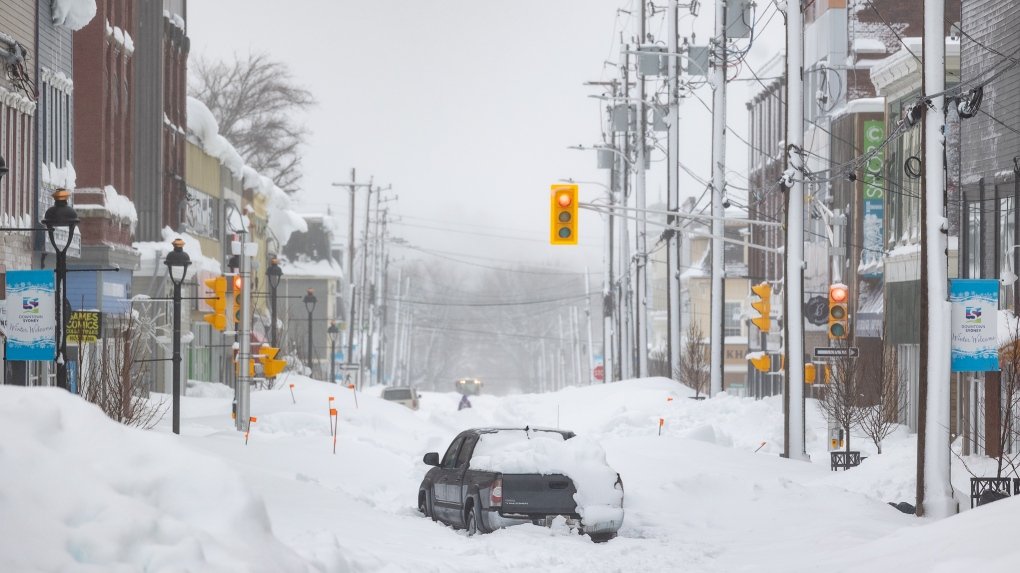 a truck is abandoned on a snow covered street 1 6757497 1707220959983